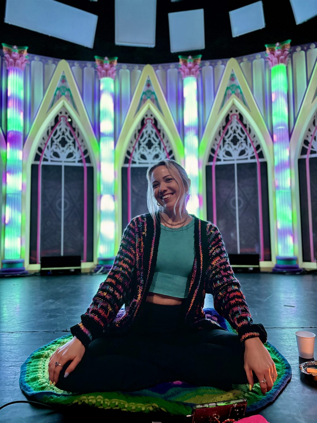 Festival-goer in a vibrant immersive light installation